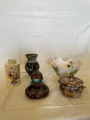 three different vases on a table with a white background
