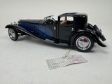 a black model of a car on a white surface