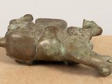 a bronze figurine of a turtle on a table