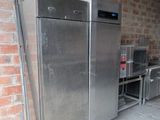an image of a stainless steel refrigerator in a garage