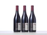 three bottles of wine sitting on top of a table