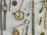 many different types of jewelry on a white table
