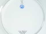 a white plate with a blue and red flower design on it