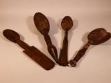three wooden spoons and a spatula on a white surface