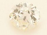 a close up of a white diamond on a white surface