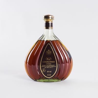a close up of a bottle of brandy on a white surface