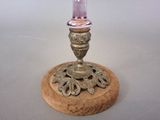 a candle that is sitting on top of a wooden stand