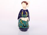 a ceramic figurine of a woman holding a cat