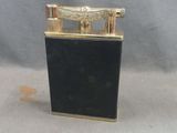 an image of a black lighter with a gold trim