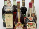 several bottles of liquor are lined up on a white surface