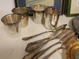 a table with silverware and a picture on the wall