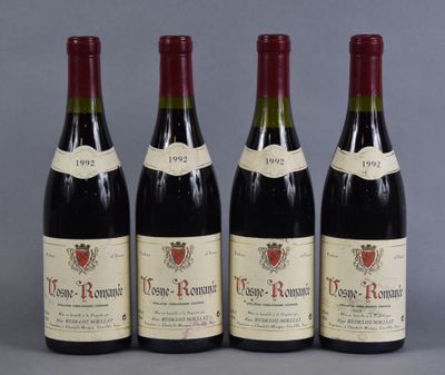 three bottles of red wine are lined up on a table