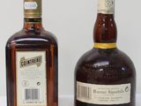 two bottles of liquor sitting next to each other on a table