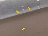 yellow arrows on the side of a gray car