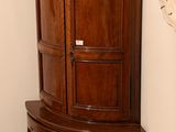 a corner cabinet in the corner of a room