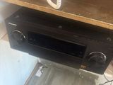 a phone on a shelf above a stereo in a room