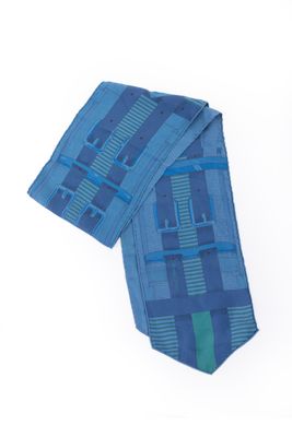 a blue neck tie with a blue and green design on it