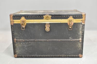 a black trunk with gold trim and brass hardware on it