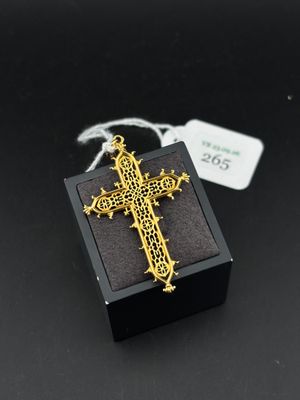 a close up of a cross on a small box with a tag
