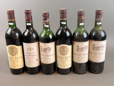 six bottles of wine are lined up in a row on a table