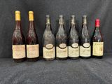 six bouteilles de vin sont alignées sur un fond noir