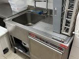 a kitchen with a sink and a dishwasher in it