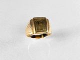 an image of a gold signet ring on a white surface