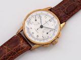 a close up of a watch on a white surface