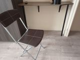 a chair that is sitting in front of a shelf