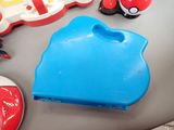 a blue plastic object with a red object on top of it