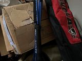 a pile of luggage and a pair of ski poles in the corner of a room