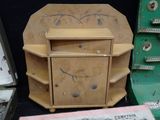 a small wooden table with a drawer and a book