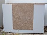 an image of a white refrigerator with a cork board on the door