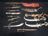 many different types of knives on a black surface