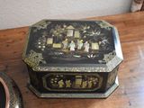 a black and gold box sitting on a wooden table