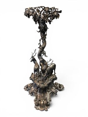 bronze sculpture of a tree with animals and a bird on it
