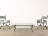 three chairs and a table in a room with a white wall