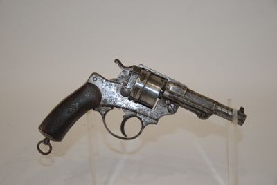 a gun that is sitting on top of a glass stand