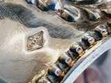 a close up of a silver ring with a lion on it