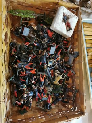 a basket full of miniature figurines sitting on a table