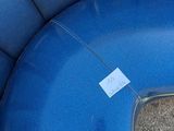 a close up of a blue seat with a tag on it