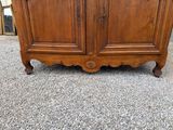 an antique wooden armoire with two doors and two drawers
