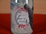 a bottle that has a picture of a peacock on it