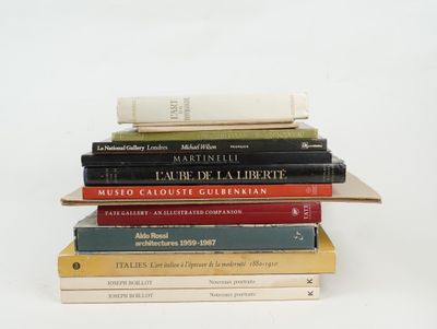 many books stacked on top of each other on a table