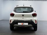 the rear end of a white car in a white room