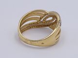 an image of a gold and diamond ring on a white surface