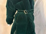 an image of a green velvet coat on a mannequin