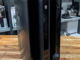 a black computer on a wooden table in a room