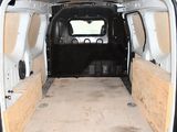the inside of a van with the door open and the back of the van in the back