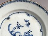 a blue and white plate with a floral design on it